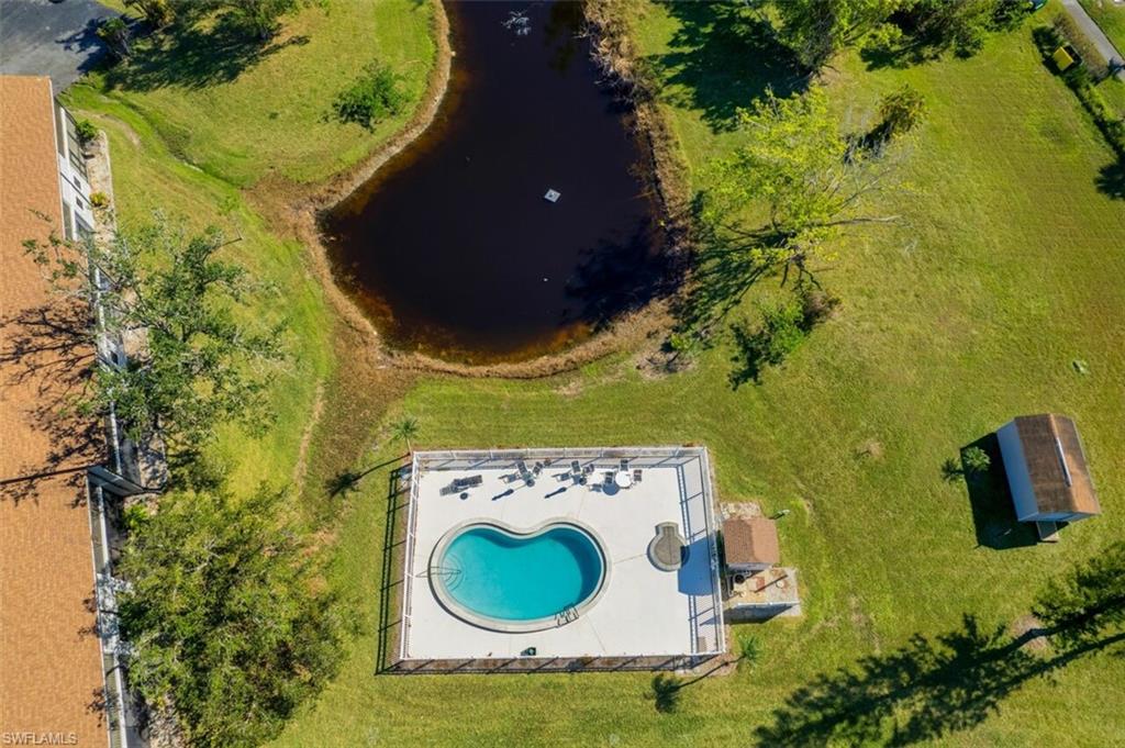 Bird's eye view of a pool area and a large body of water