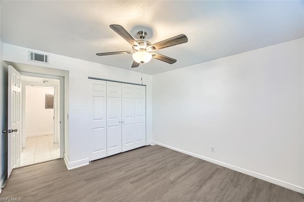 Unfurnished bedroom with wood finished floors, a closet, and ceiling fan