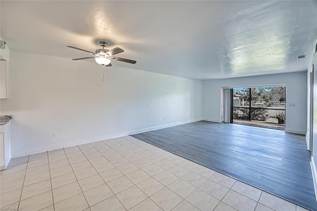 Unfurnished room featuring light tile patterned flooring and a ceiling fan