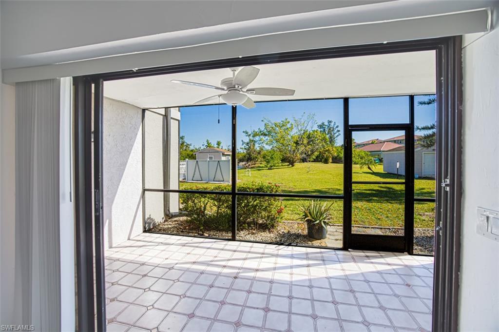 Unfurnished sunroom with a ceiling fan