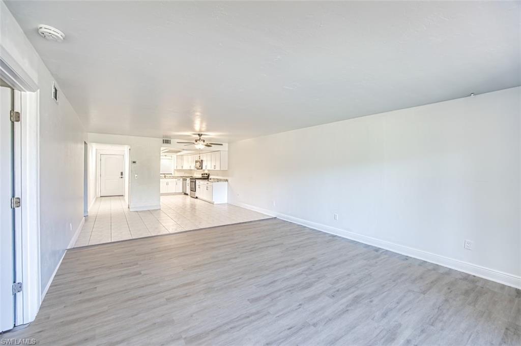 Unfurnished living room featuring light wood-style flooring and a ceiling fan