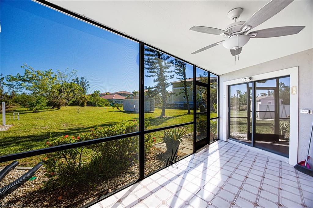 Unfurnished sunroom featuring a ceiling fan