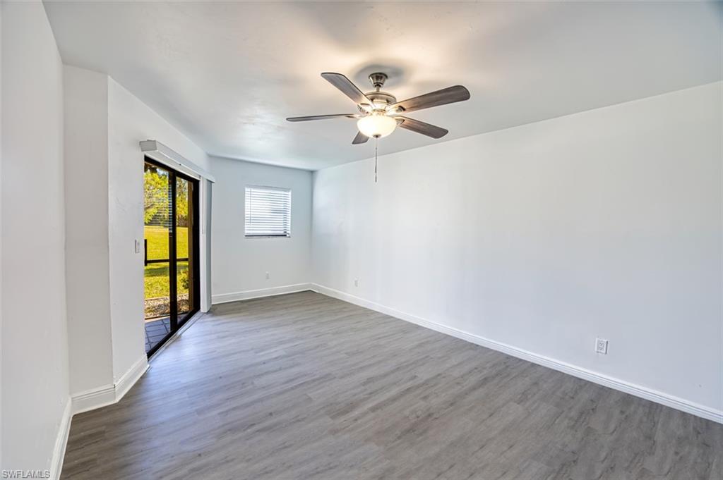 Spare room with wood finished floors and a ceiling fan