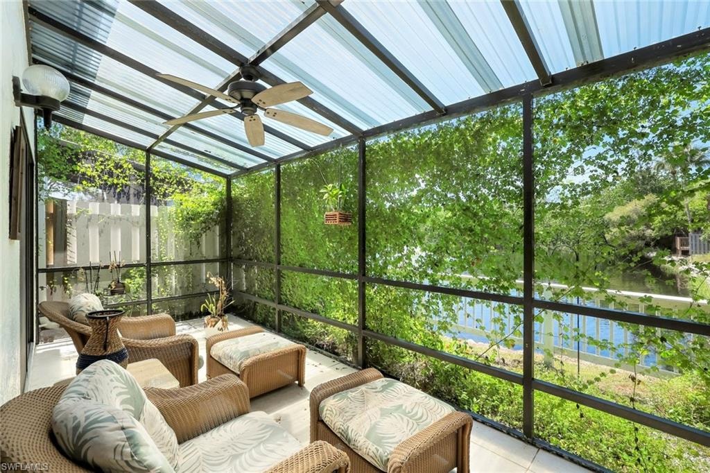 Sunroom with a water view and ceiling fan