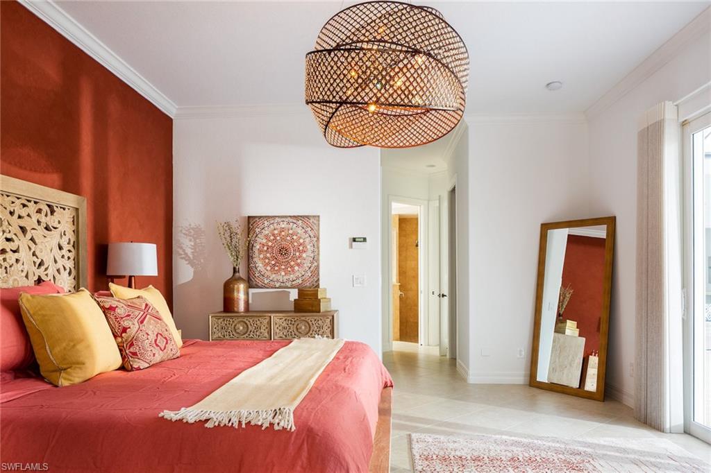 Bedroom with crown molding, a chandelier, and light tile patterned floors