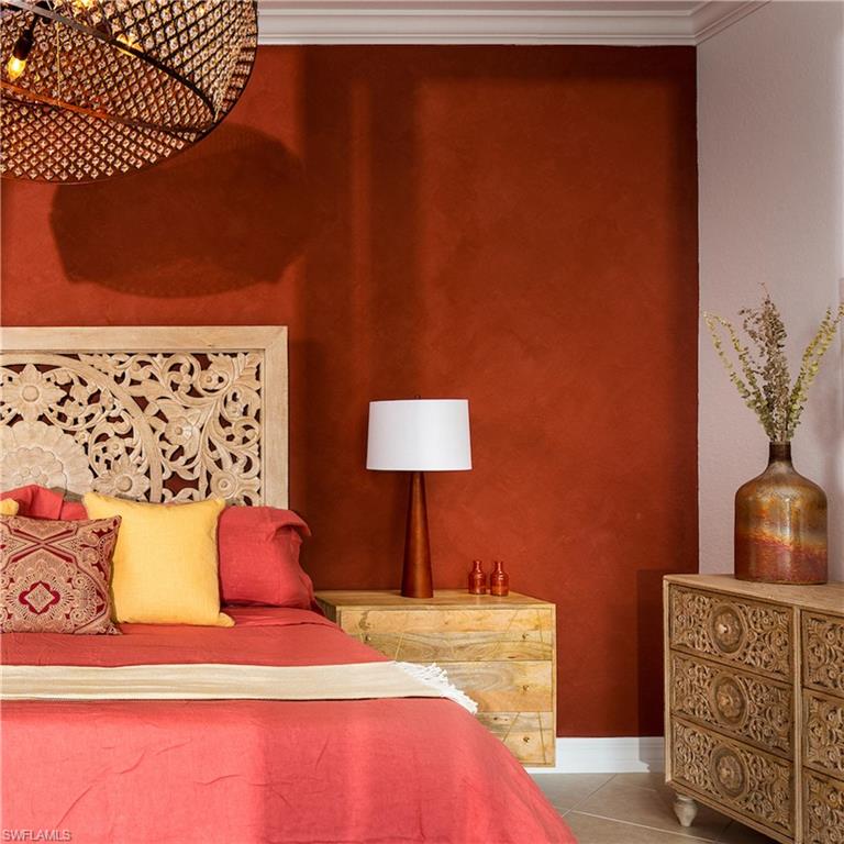 Tiled bedroom with ornamental molding and baseboards