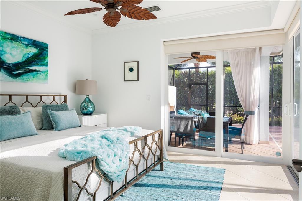Tiled bedroom with a sunroom, ornamental molding, access to exterior, and ceiling fan