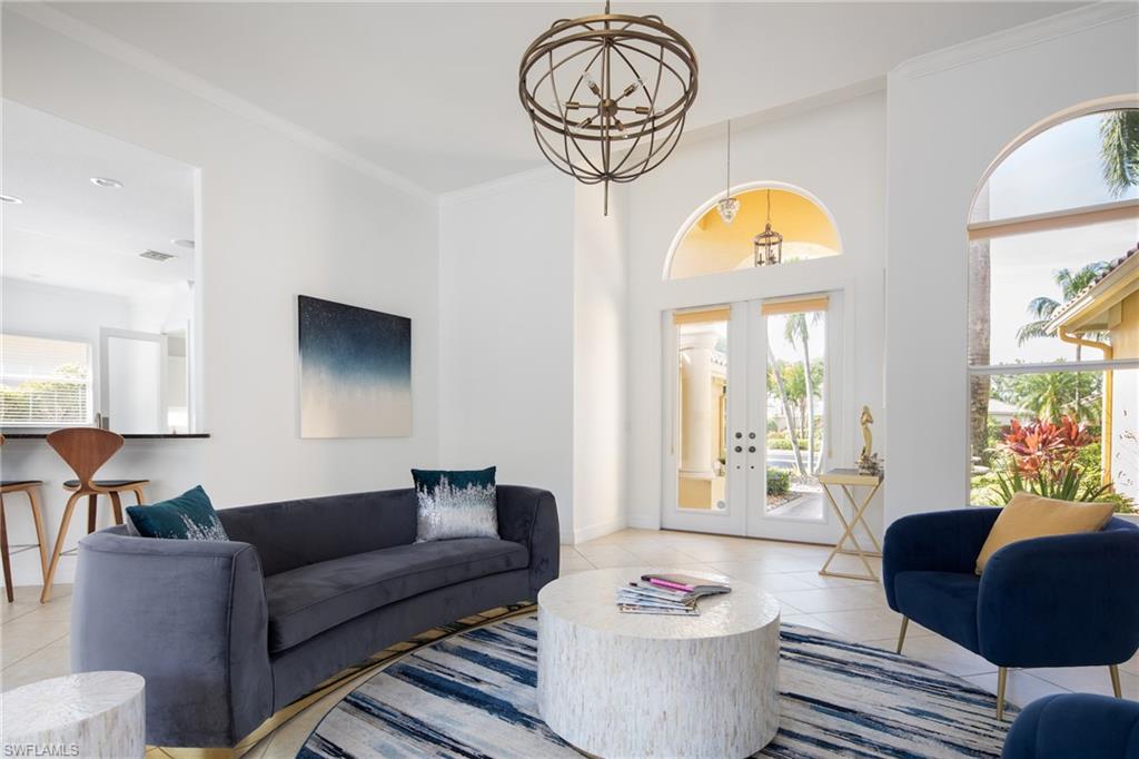 Living area featuring french doors, ornamental molding, and light tile patterned floors
