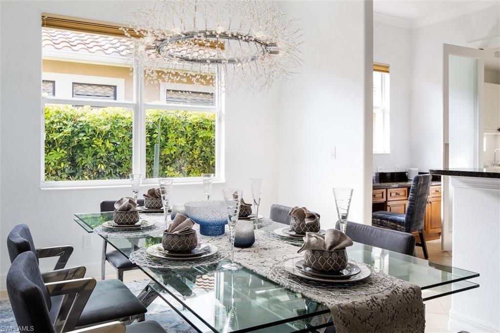 Dining room with ornamental molding and a chandelier
