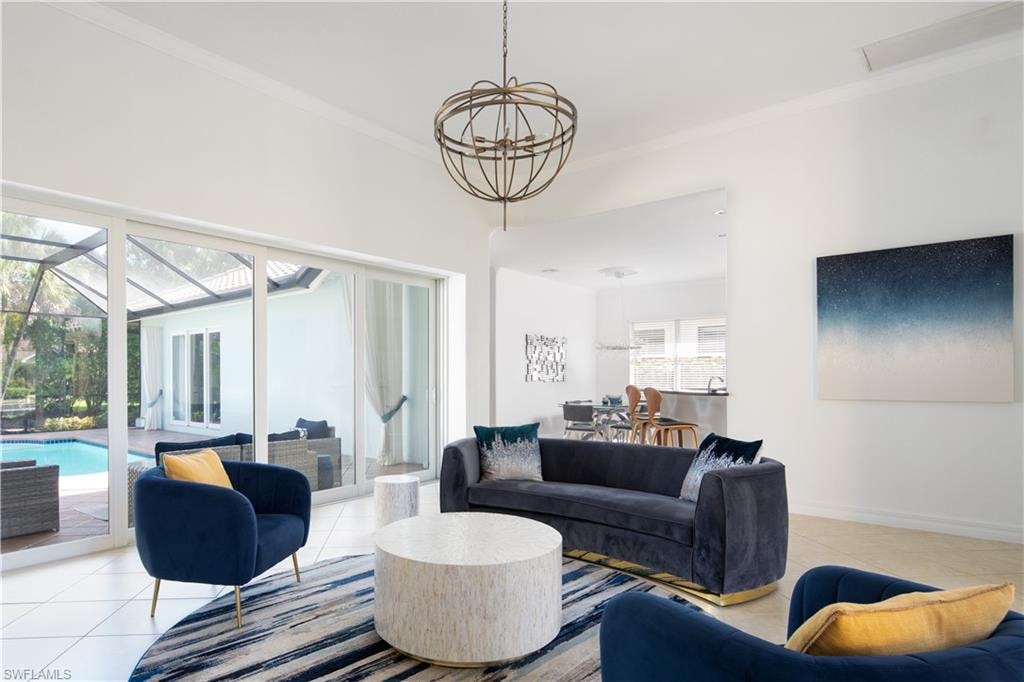 Tiled living area featuring crown molding and baseboards