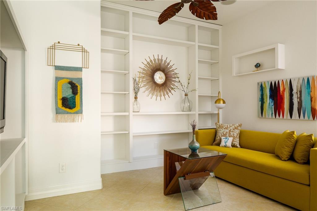 Living room featuring a ceiling fan and tile patterned floors