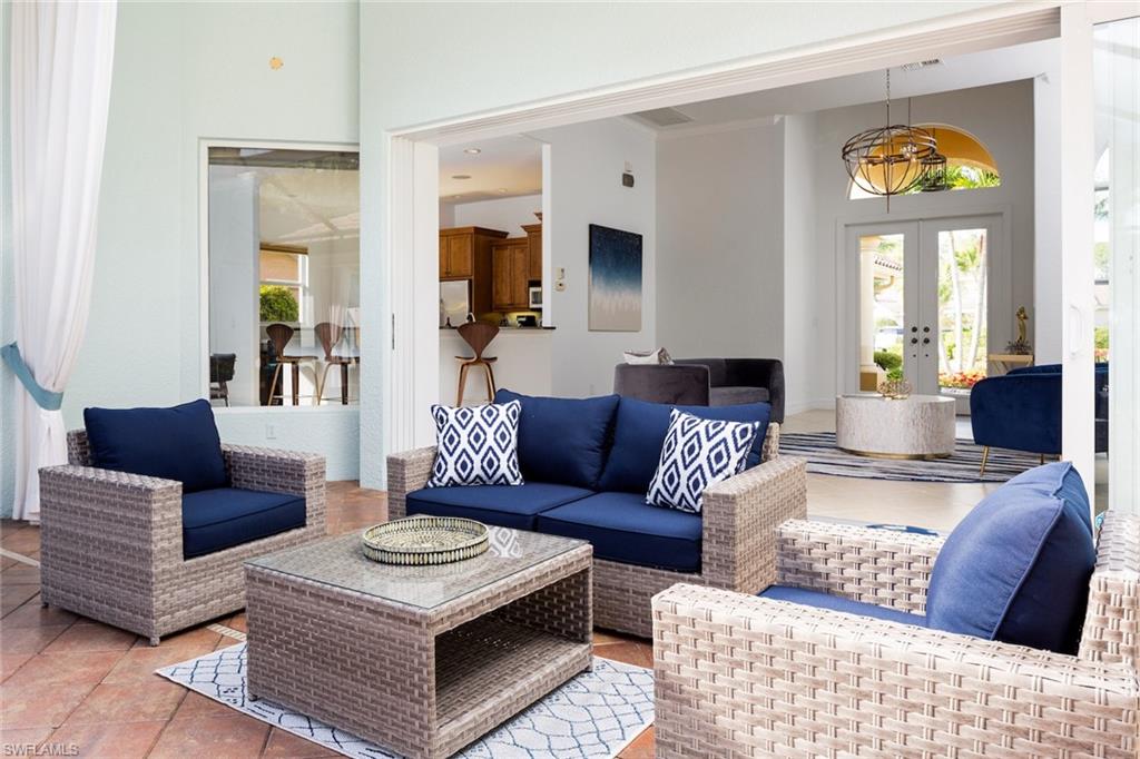 Tiled living room featuring french doors