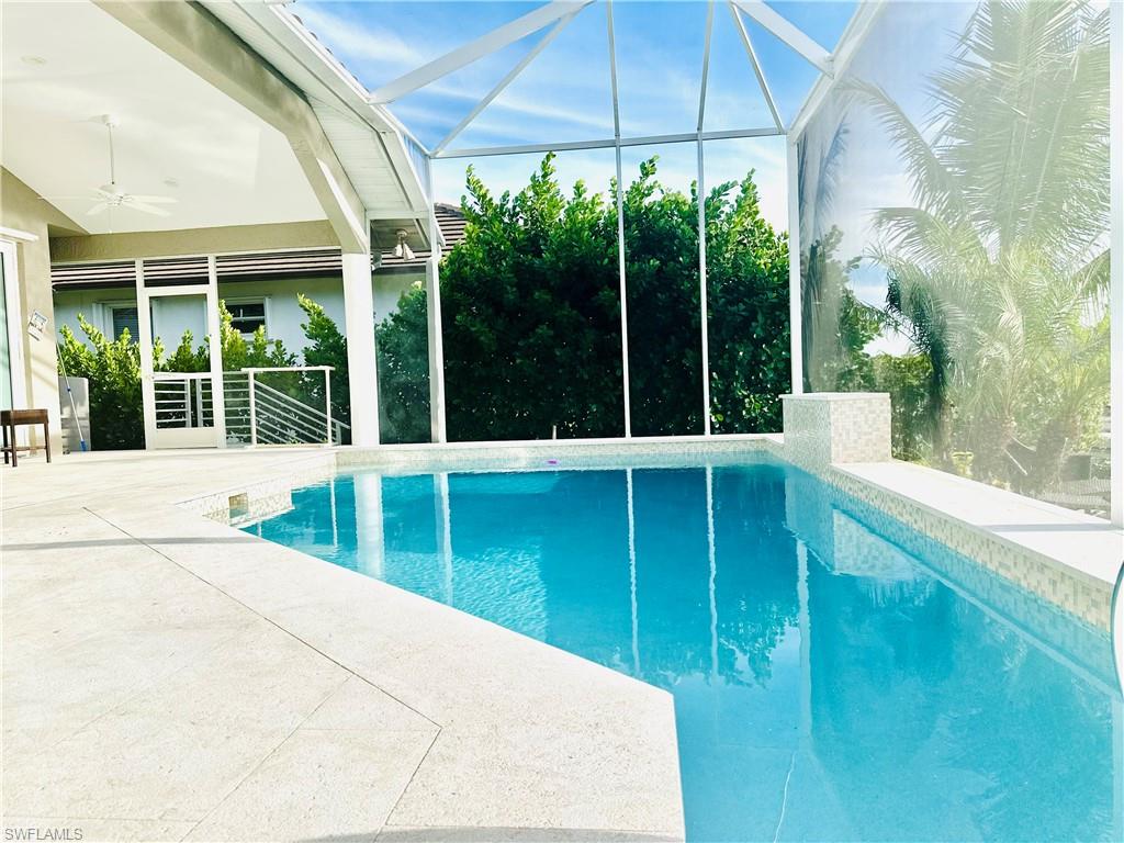 Swimming pool featuring a lanai, a patio, a ceiling fan, and a sunroom