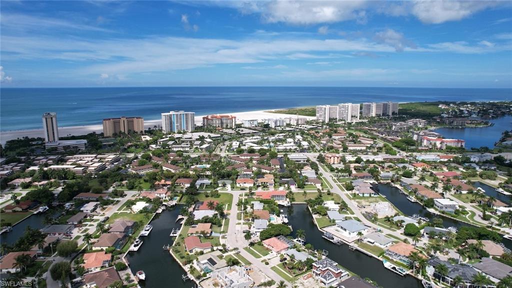 View of property location with a nearby body of water and nearby suburban area