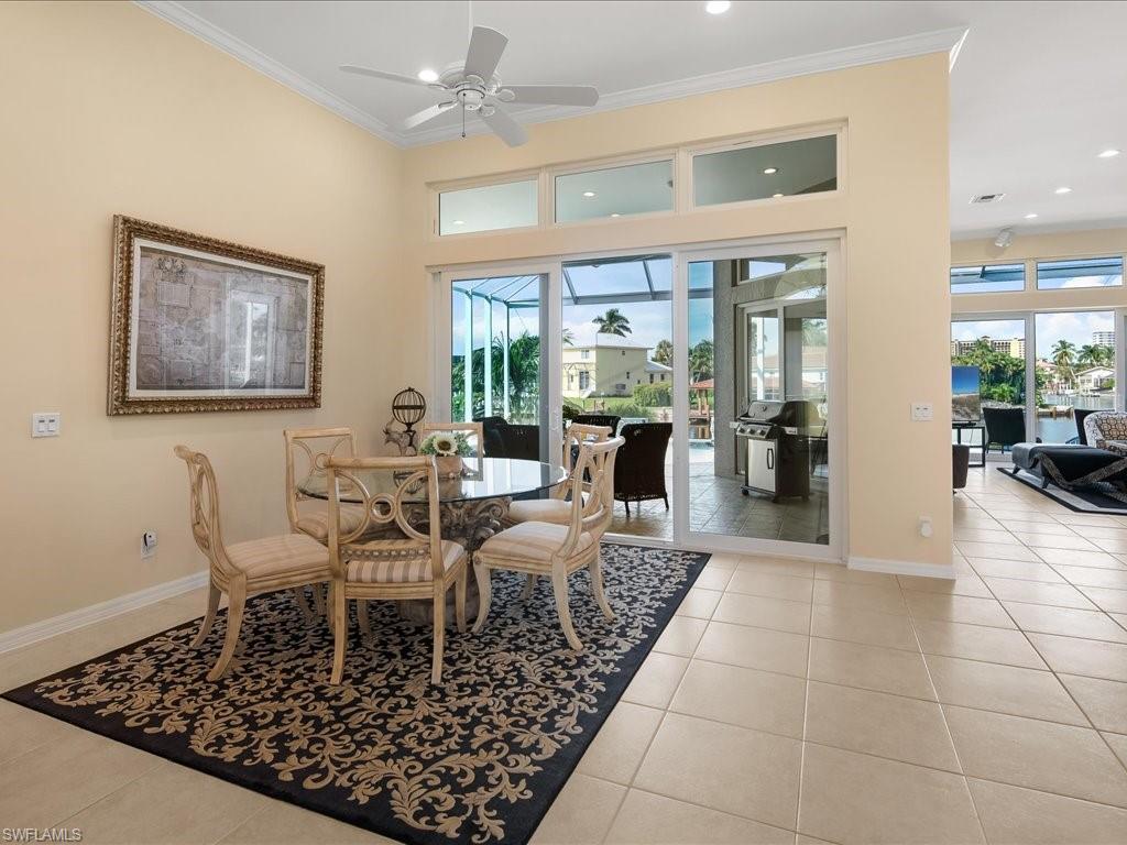 Dining room featuring light tile patterned floors, crown molding, plenty of natural light, recessed lighting, and ceiling fan