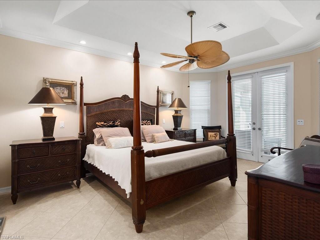 Bedroom with crown molding, french doors, light tile patterned floors, access to outside, and a ceiling fan