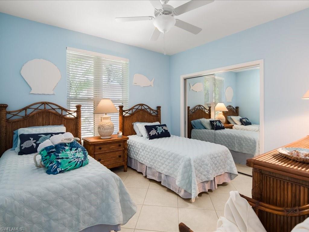 Bedroom featuring light tile patterned flooring and ceiling fan