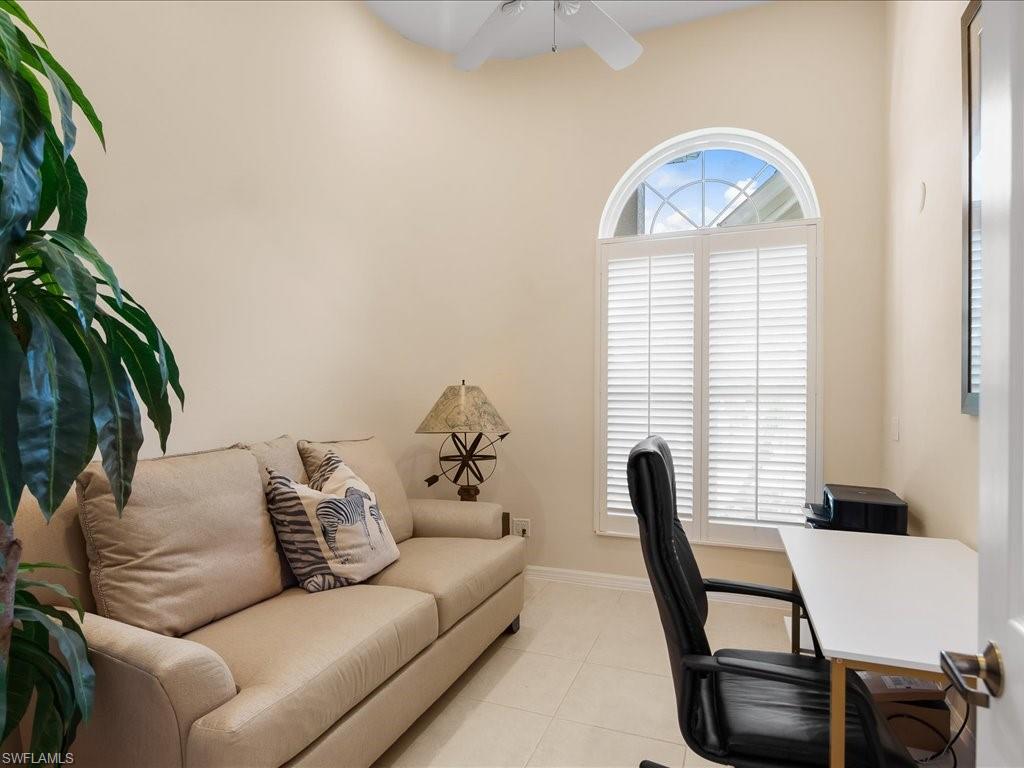 Office area featuring light tile patterned floors and a ceiling fan