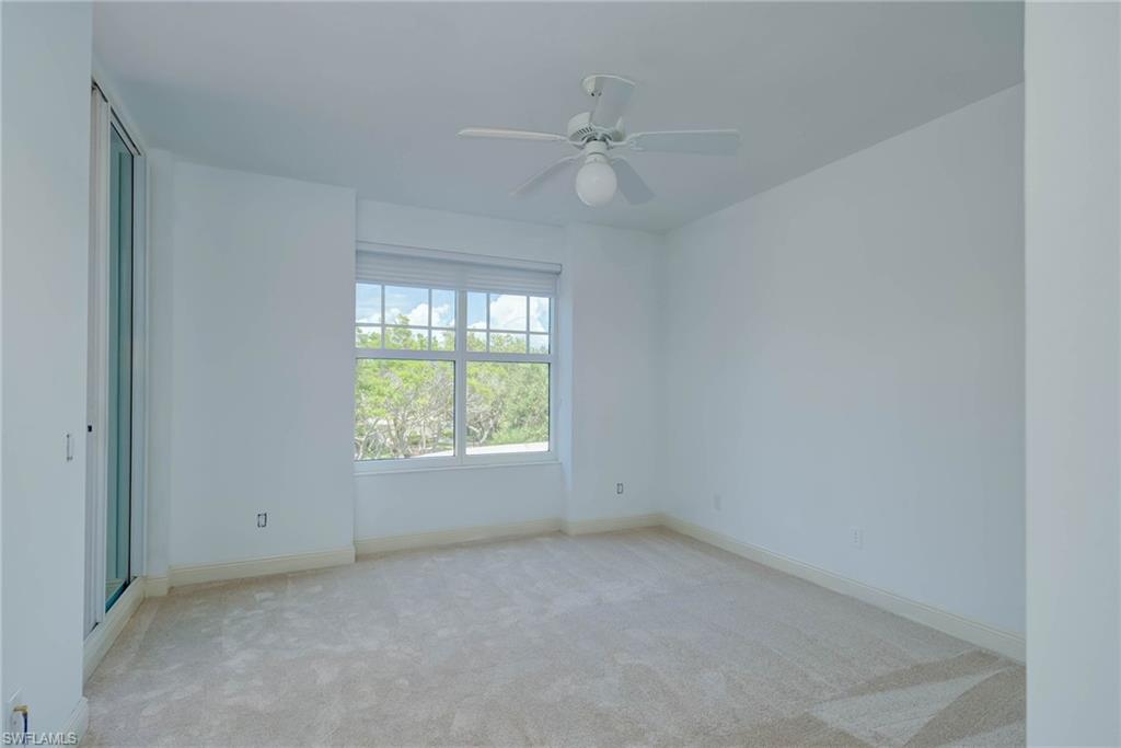 Guest Bedroom featuring light colored carpet and ceiling fan facing Front Balcony