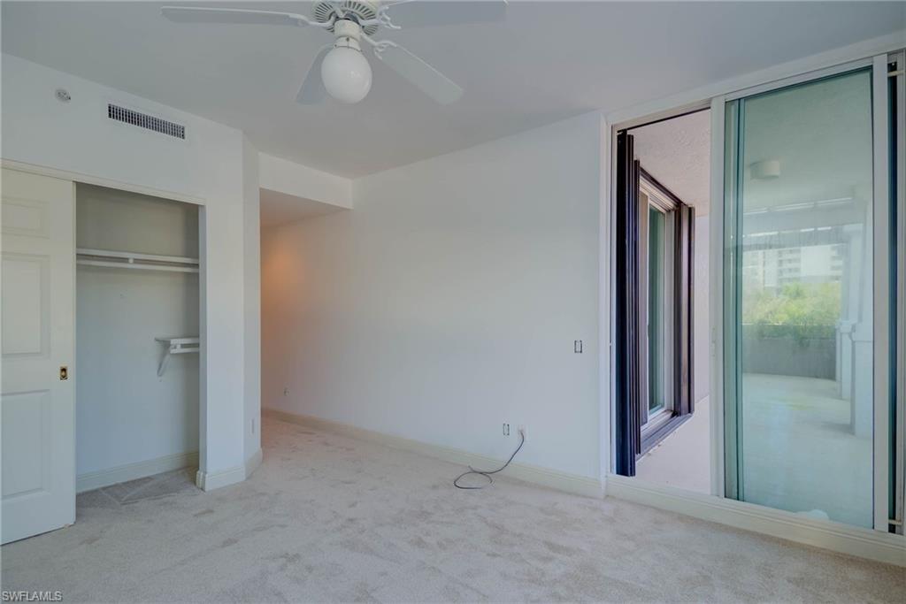 3rd Bedroom with carpet floors, ceiling fan, and a closet. Sliders to Front Balcony - Private Bath