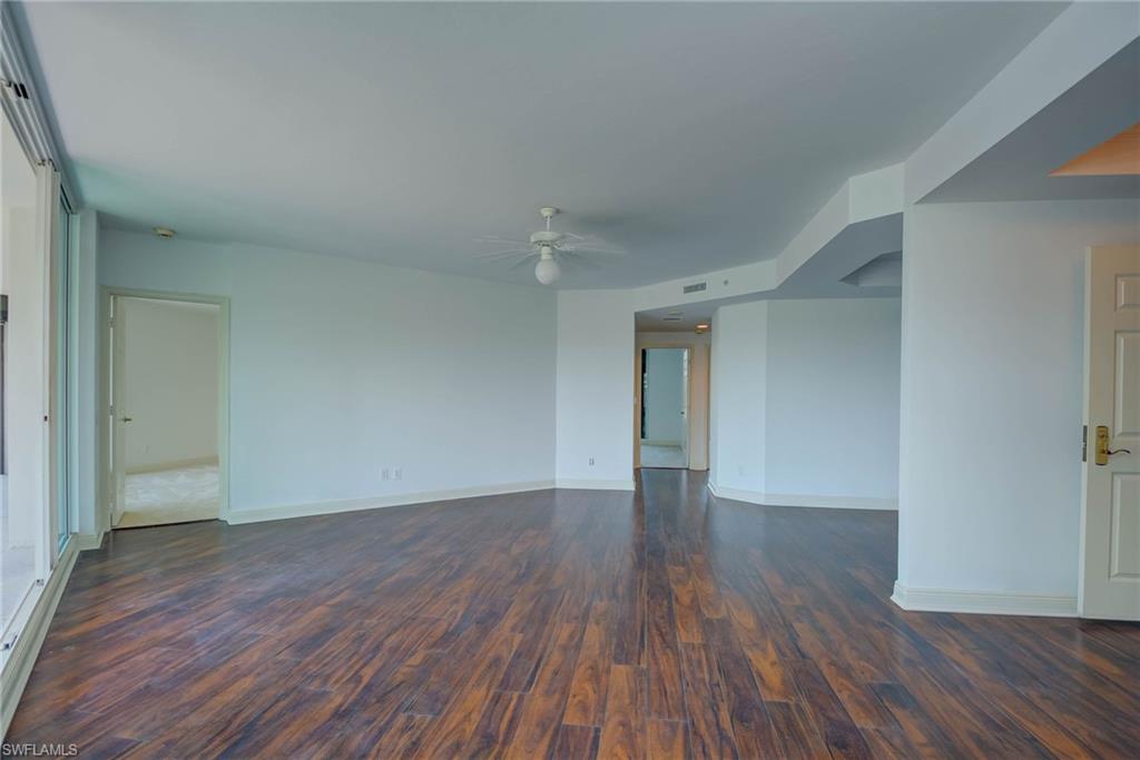 Empty room featuring dark wood finished floors and ceiling fan