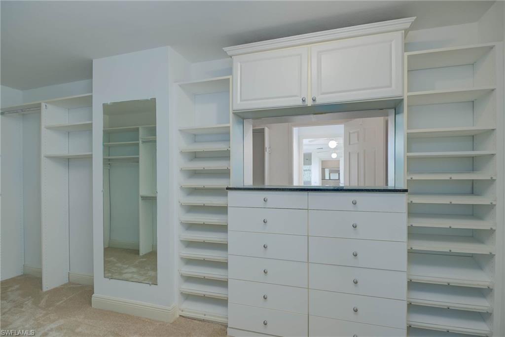 View of closet w/built in drawers and Shoe Shelves