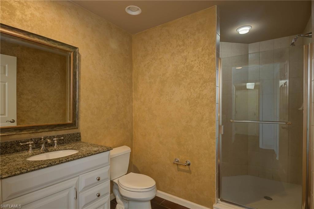 Bathroom featuring a stall shower and vanity
