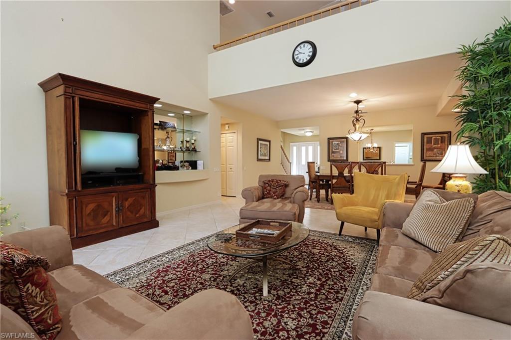 Tiled living room with a high ceiling