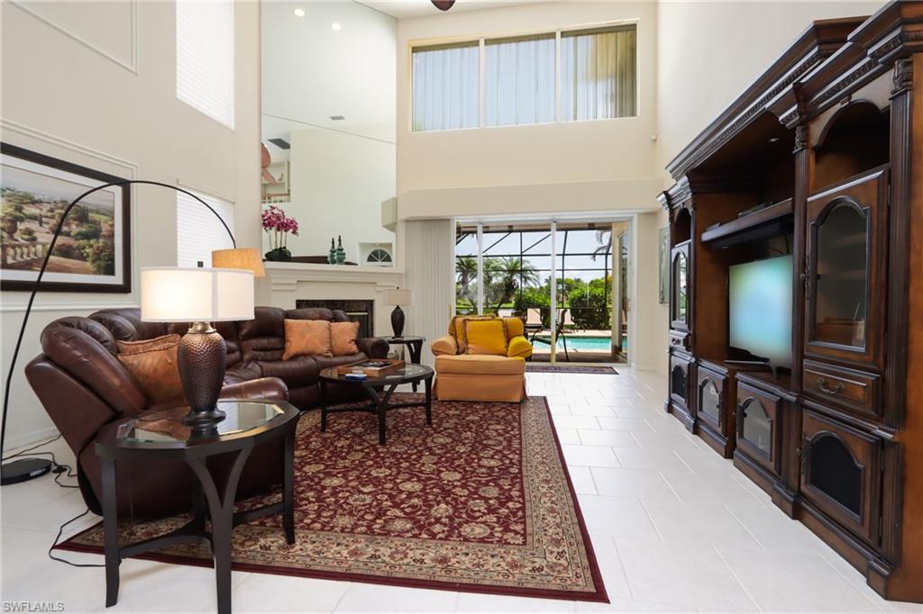 Tiled living room featuring a high ceiling