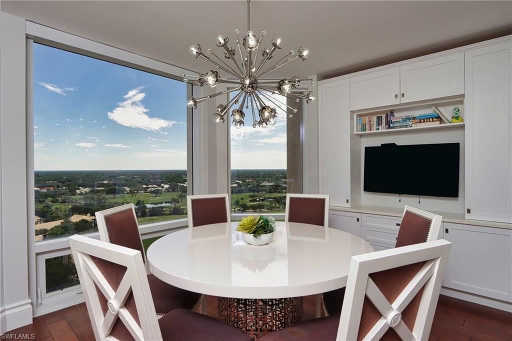 Dining area with an inviting chandelier and dark hardwood / wood-style floors