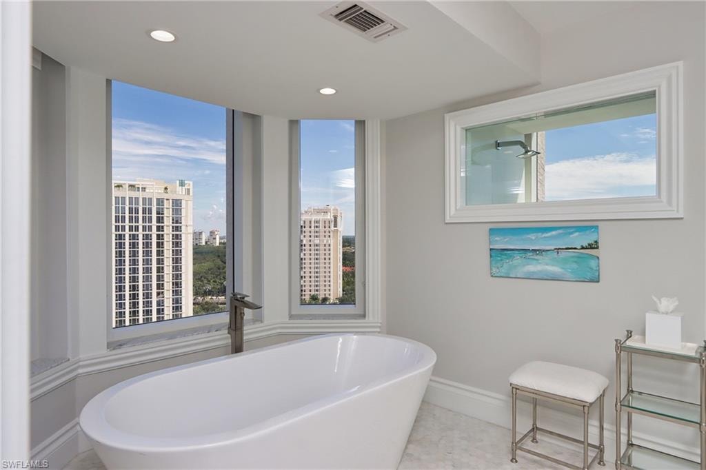 Bathroom with a bath and a wealth of natural light