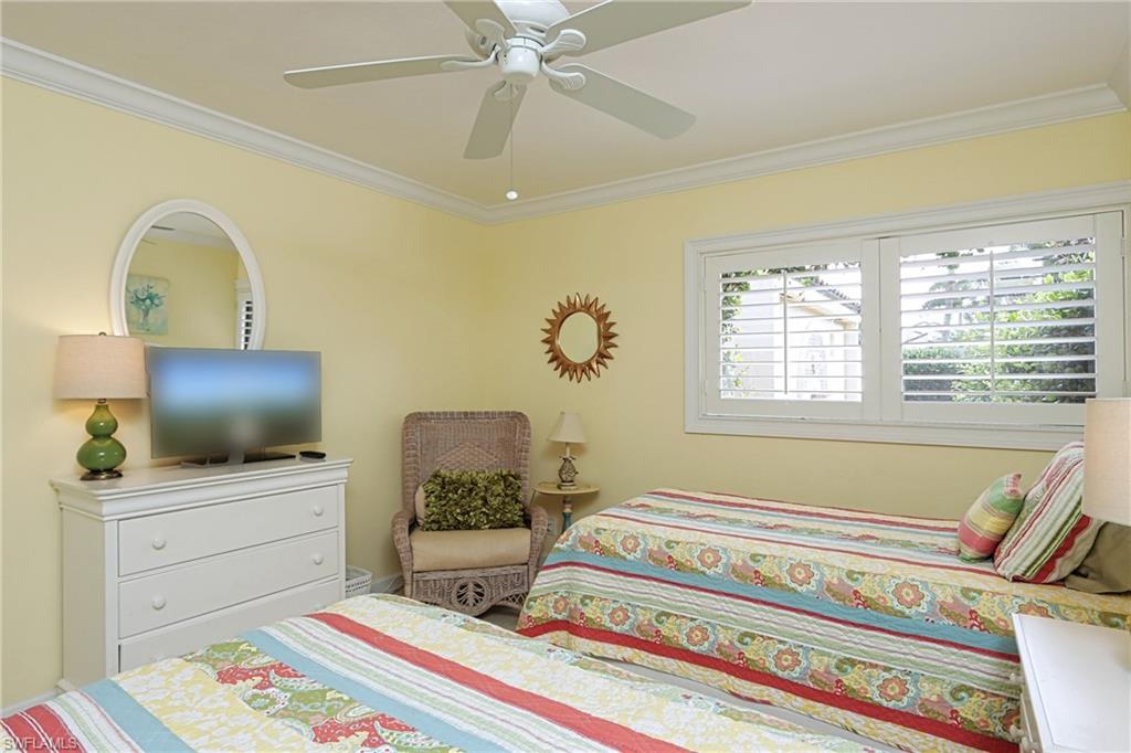 Bedroom featuring ceiling fan and crown molding