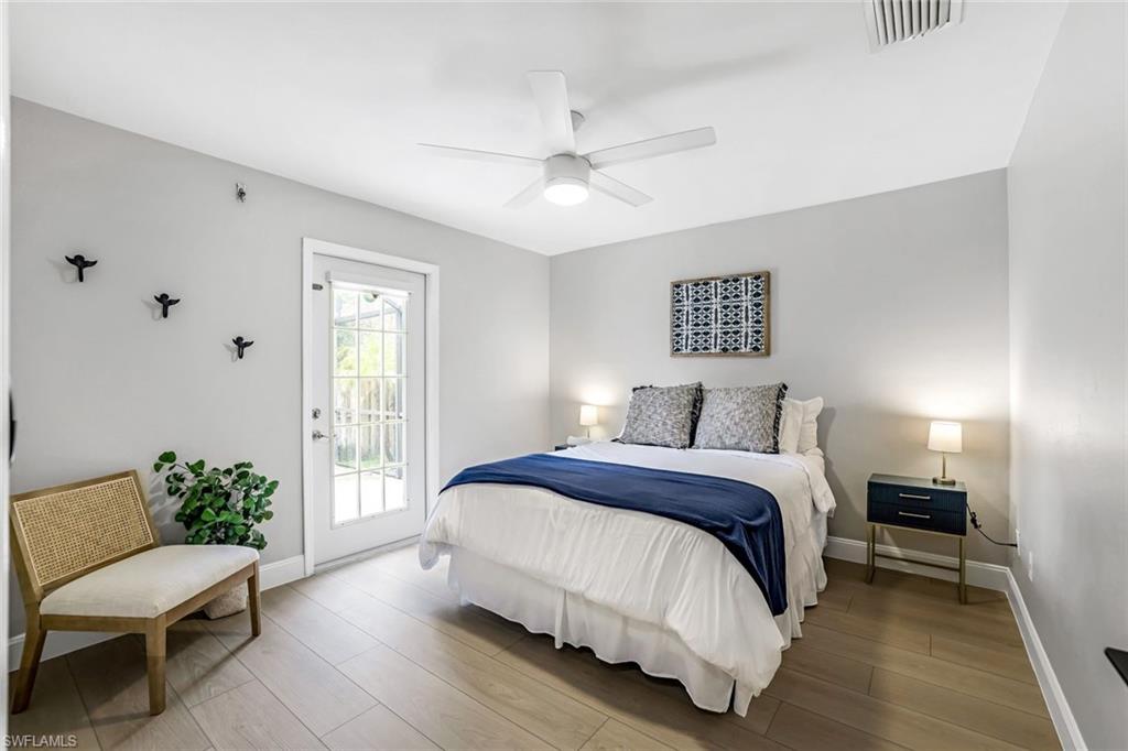 Bedroom with access to exterior, wood finished floors, and ceiling fan