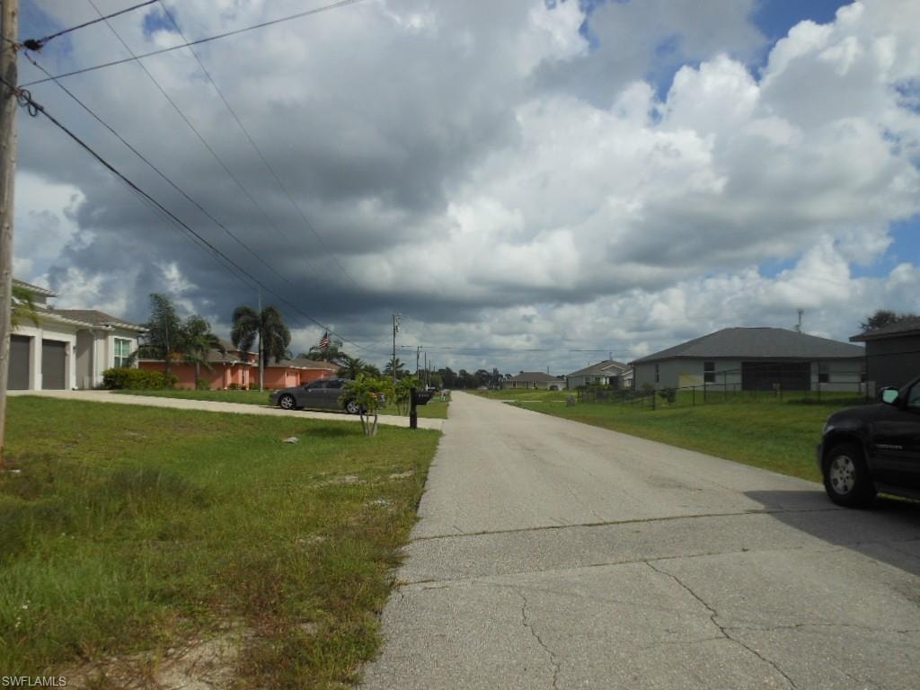 View of asphalt street with a residential view
