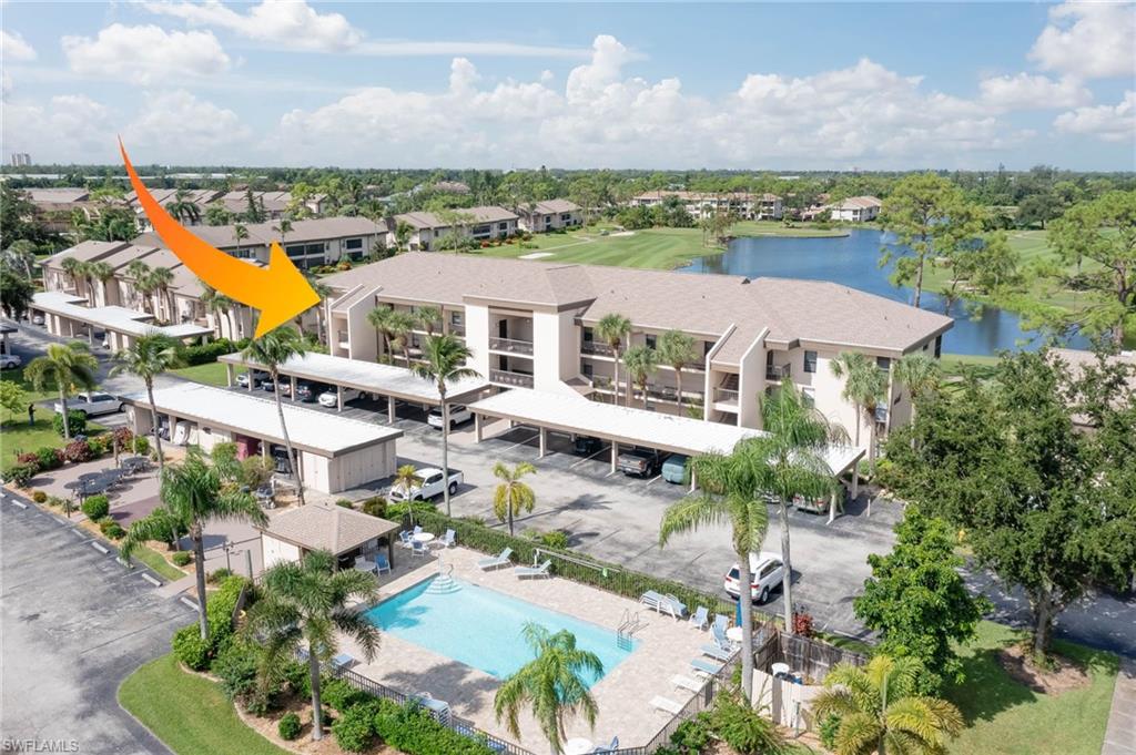 Drone / aerial view of a nearby body of water and a golf course