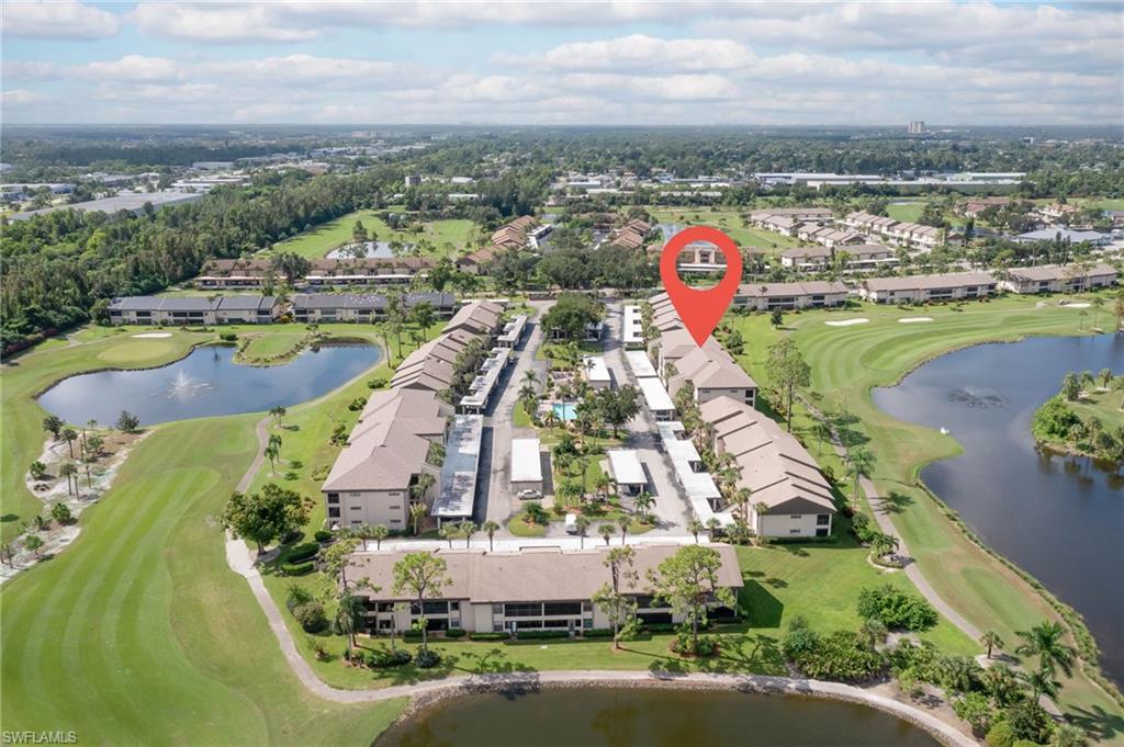 Aerial view of property and surrounding area with a local golf course and nearby suburban area