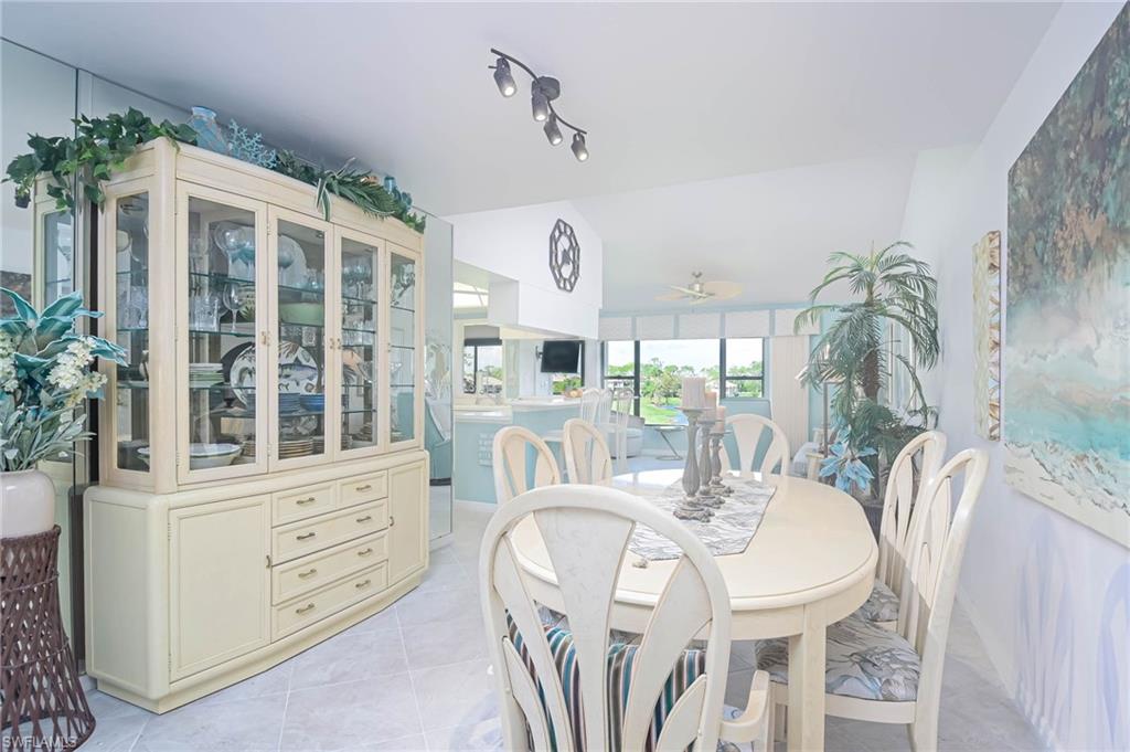 Dining space featuring light tile patterned floors and ceiling fan