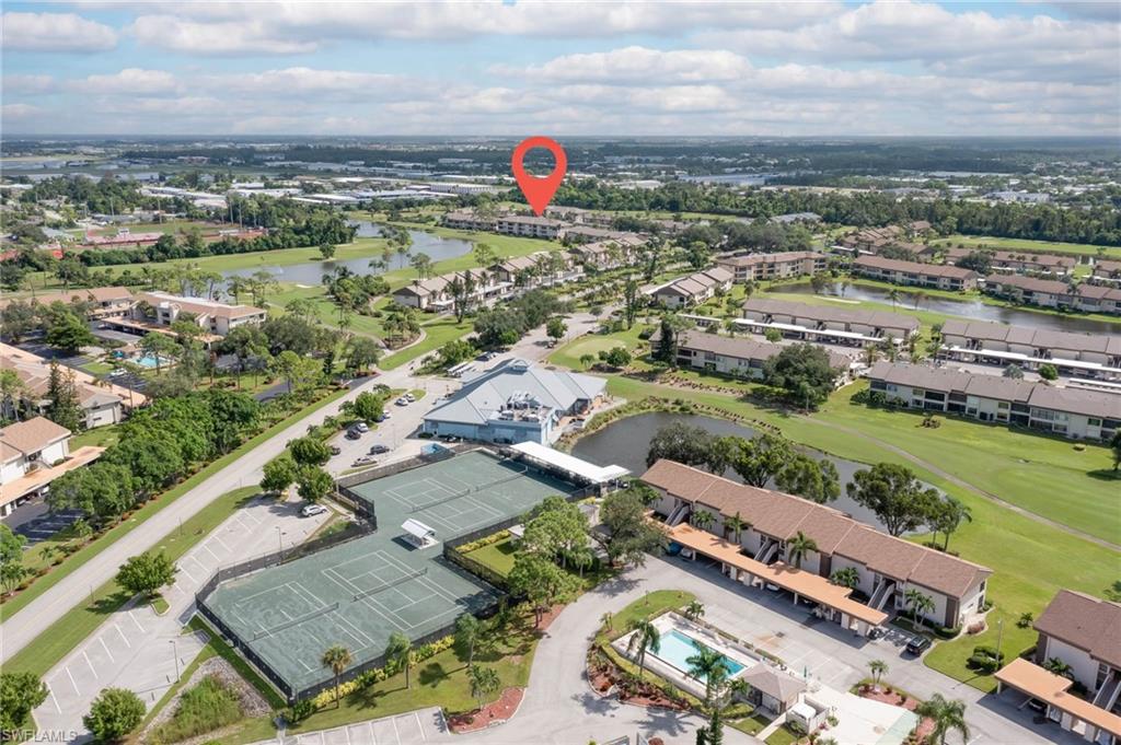 Aerial view of property's location featuring a large body of water and a golf club