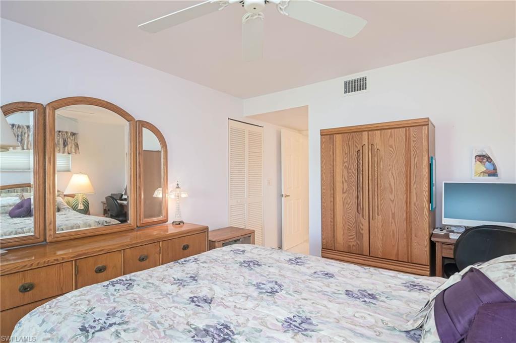 Bedroom with a closet, ceiling fan, and a desk