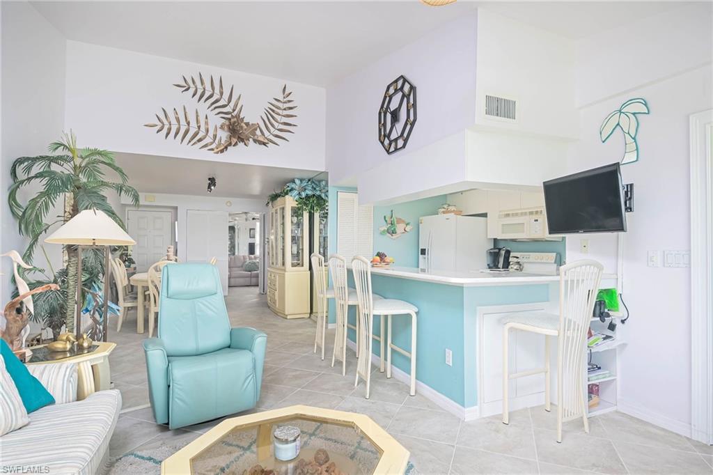 Living room with light tile patterned floors and baseboards