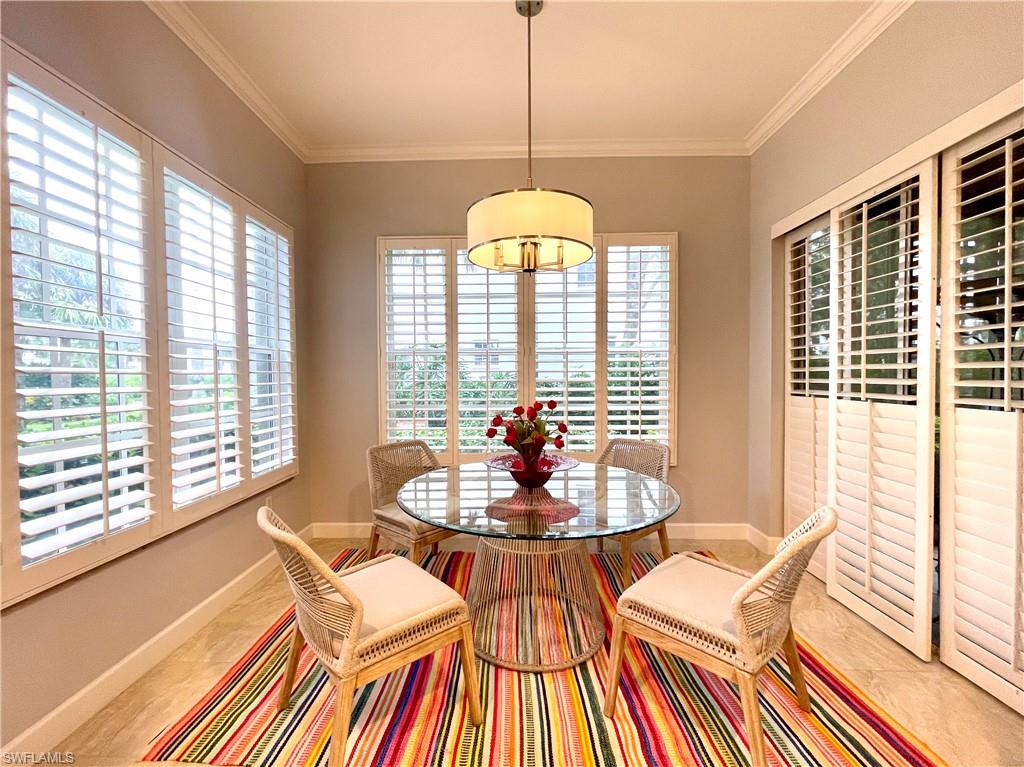 Dining room with healthy amount of natural light and ornamental molding