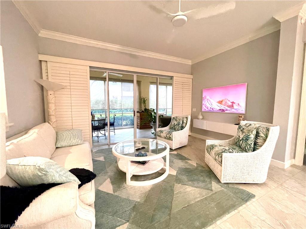 Living room featuring ornamental molding and tile patterned floors