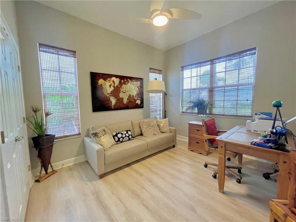 Office area featuring light wood-style flooring and a ceiling fan