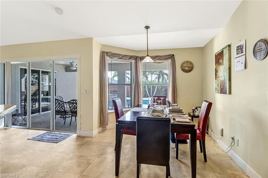 Dining space with baseboards and vaulted ceiling