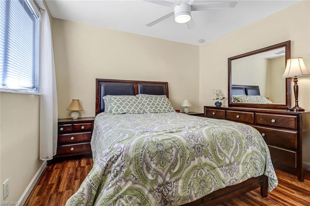 Bedroom with dark wood finished floors and a ceiling fan