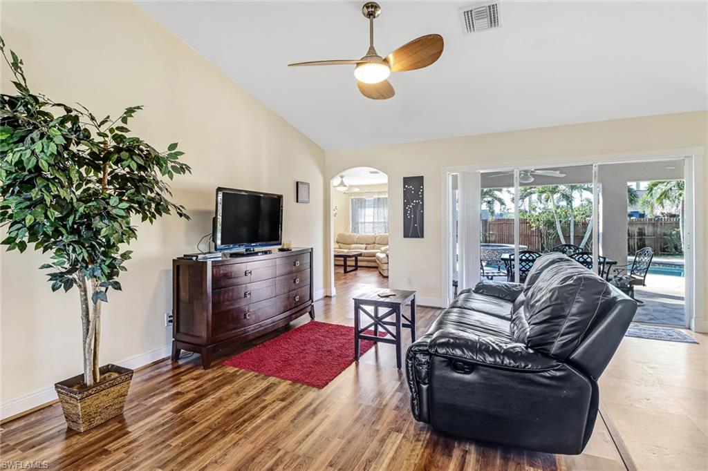 Living room with wood finished floors and a ceiling fan