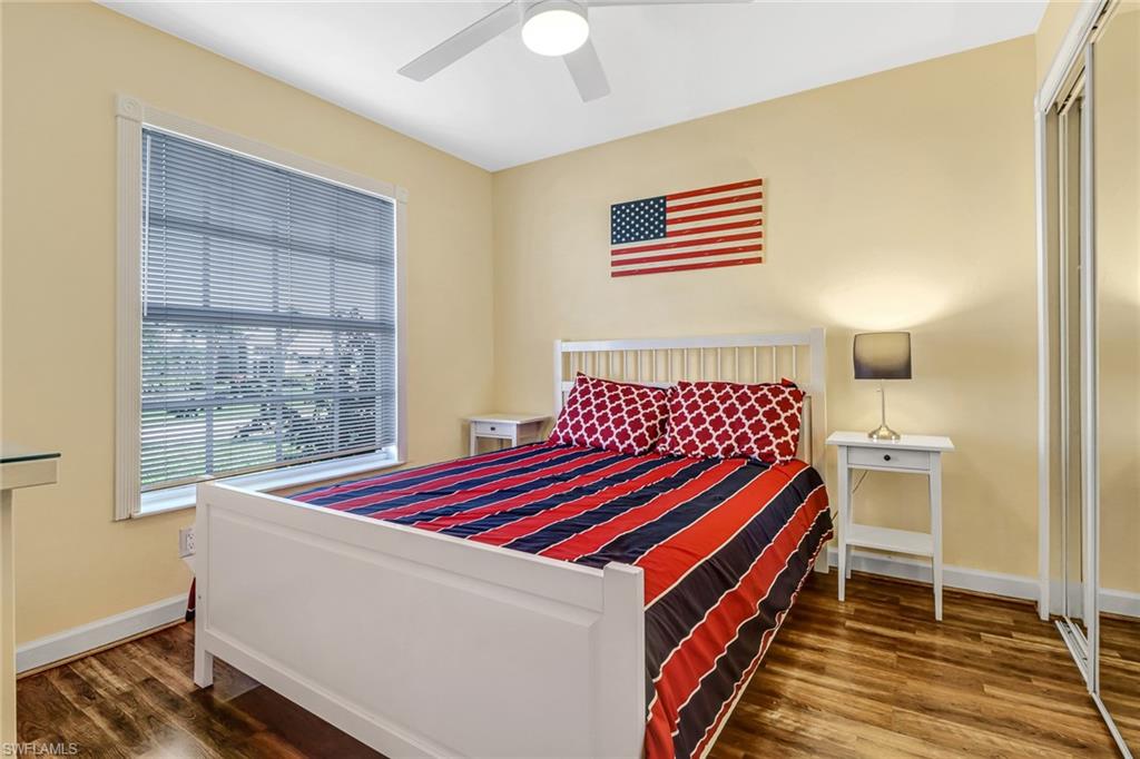 Bedroom with dark wood-style floors and ceiling fan
