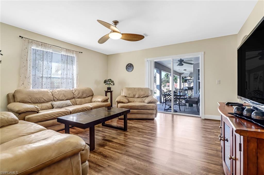 Living room with wood finished floors and a ceiling fan