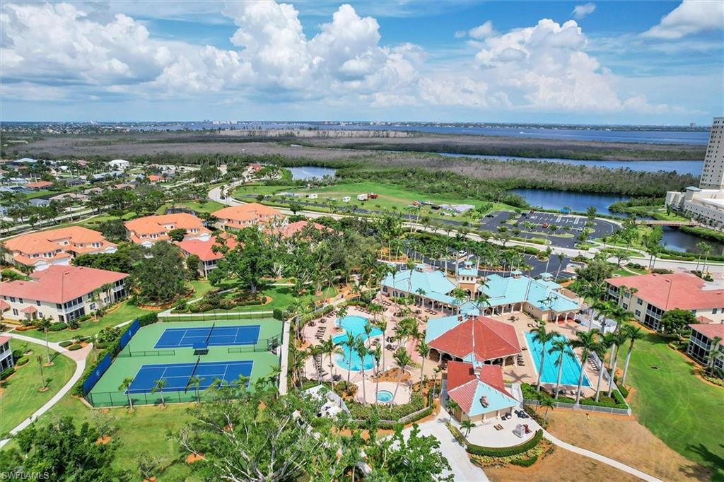 Drone / aerial view of a pool and a nearby body of water
