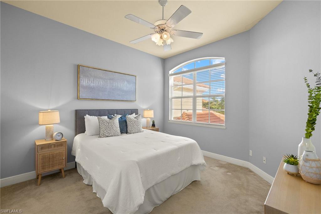 Bedroom with ceiling fan, carpet floors, and baseboards
